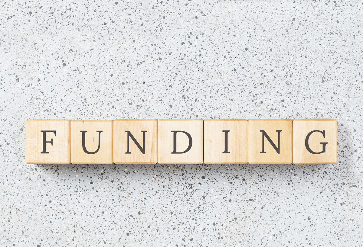 The word funding spelled out in Scrabble tiles