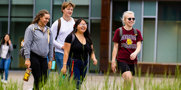 Group of college students walking together outdoors.